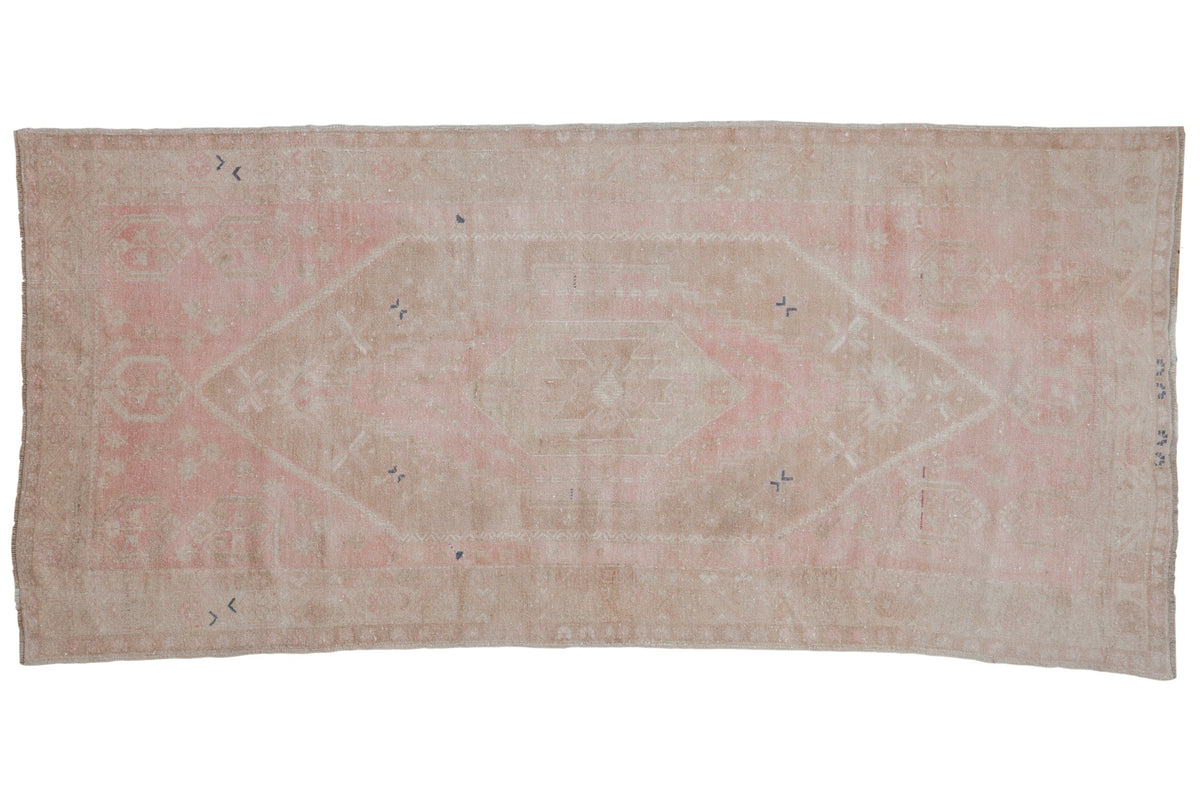Distressed Oushak rug runner with concentric stepped medallions in pale pink, beige, and hints of cobalt blue.