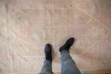 A view showing the scale and soft, worn texture of the distressed Oushak runner.