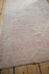 Close-up of a distressed Oushak runner's low pile, showing mostly even wear to the knot heads.