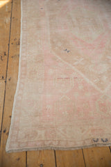 A close-up of the distressed, low pile and secured side selvage on a vintage Oushak rug.