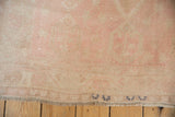 Reverse of the hand-knotted Oushak rug showing the foundation weave and painted inventory numbers.