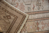 Distressed vintage Turkish Oushak rug highlighting hand-knotted pile and visible woven foundation.