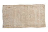 Distressed vintage Oushak hand knotted runner with subtle ivory floral design and mostly even wear, 2'3