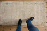 Distressed vintage Oushak runner with subtle floral design, soft worn texture, and neutral tones.