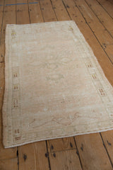 Distressed Oushak runner, subtle floral patterns, mostly even wear, ivory and beige.