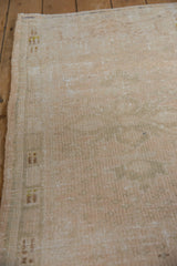 Distressed vintage Oushak rug texture showing mostly even wear with soft beige and antique ivory.
