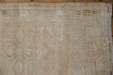 Reverse of distressed Oushak rug, revealing hand-knotted foundation and painted markings.