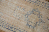 Distressed vintage Oushak runner texture, worn denim blue patterns, foundation visible.
