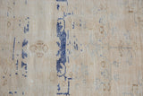 Distressed Oushak rug detail showcasing mostly even wear, visible foundation, and faded cobalt blue patterns.
