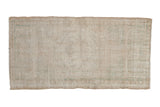 Distressed vintage Oushak rug runner with faded ivory, beige, seafoam floral medallion, 1'11