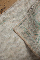 Close-up of hand-knotted foundation and textured distressed pile on Oushak rug.