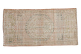 Distressed Oushak runner in pale rose, ivory, oxidized green, subtle floral medallion, 2'2