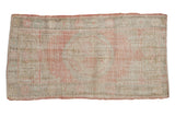 Distressed Oushak rug runner, faded rose medallion, ivory floral border.