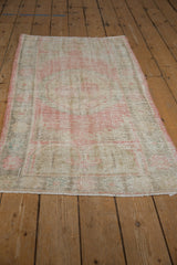 Distressed pile texture with faded rose floral patterns and exposed foundation.