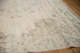 Distressed blush and ivory field with subtle patterns and intact side selvage.