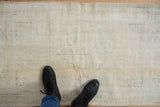 Distressed vintage Oushak rug runner pile, showing worn ivory, beige, and sage green.