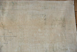 Textural view of distressed Oushak runner pile, showing ivory, beige, and oxidized silver tones.