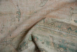 Low pile distressed Oushak texture in pale beige pink, ocean green, and oxidized silver tones.