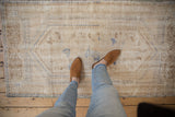 Vintage Distressed Oushak rug's textured pile, showing faded ivory, pale denim, and coffee brown patterns.