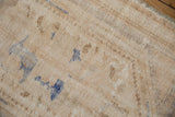 Beige foundation of a distressed vintage Oushak rug showing painted numbers.