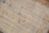 Distressed texture and worn knot heads on vintage Oushak rug, ivory and pale blue.
