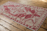 Distressed side selvage and geometric floral pattern of the vintage Oushak rug runner.