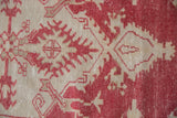 Vintage Oushak rug detail: dusty raspberry red and beige floral palmettes with distressed texture.