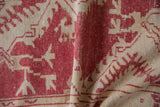 Distressed vintage Oushak rug showing dusty raspberry and beige stylized pattern with worn knot heads.