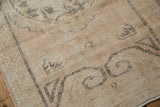 Distressed Oushak rug runner detail showing low pile texture and soft ivory-beige pattern.