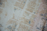 Characterful distressed texture of a vintage Oushak rug, with ivory, beige, and blue tones.