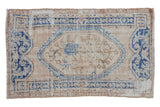 Distressed vintage Oushak rug with ivory and denim blue medallion, sprawling vines, 2'9