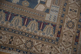 Vintage Distressed Oushak rug corner, showing blue, ivory, and sand geometric border patterns.
