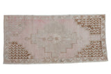 Distressed vintage Oushak rug runner, faded pink stepped medallion, floral border, beige and bronze.