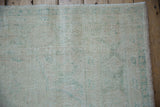 The soft, worn pile and exposed knot heads of a vintage Oushak carpet.