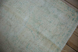 Distressed vintage Oushak carpet showing the nubby texture and wear to the knot heads.
