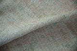 Distressed hand-knotted pile of a vintage Oushak with soft ivory, rose, and sea foam hues.