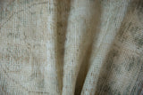 Textured vintage Oushak rug runner with distressed ivory pile and muted olive accents.