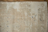 Distressed vintage Oushak rug texture showing abrash, wear, ivory, brown, and navy accents.