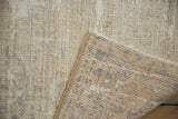 Textural view of distressed ivory Oushak pile with navy and green hand-knotted foundation.