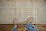 Vintage distressed Oushak rug with worn ivory and cream pile and subtle seafoam green.