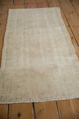 Hand-knotted ivory foundation of distressed Oushak runner, showing wear and subtle green hues.