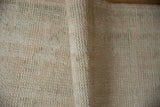 Ivory hand-knotted foundation texture of the vintage Turkish Oushak rug.