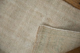 Worn pile texture and hand-knotted foundation on the reverse of a vintage Oushak rug.