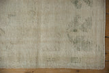 Vintage distressed Oushak rug's reverse showing green processing numbers.