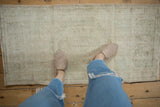 Distressed Oushak runner with visible texture, ivory, pale seafoam green, and dark beige.