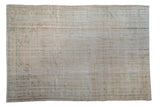 Distressed vintage Oushak carpet with faded floral medallion in soft rose, ivory, and mint.