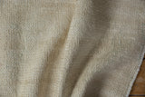 Textured ivory foundation of a distressed vintage Oushak rug, highlighting wear.