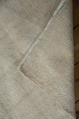 Ivory-toned back of the Oushak rug, showing foundation weave and intact selvage.