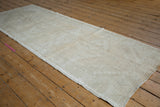 Faded geometric patterns and mostly even wear on a distressed vintage Oushak runner.