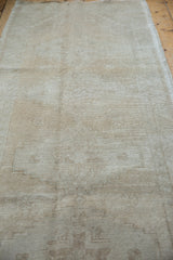 Vintage Oushak runner in antique ivory and beige, with mostly even wear showing foundation.
